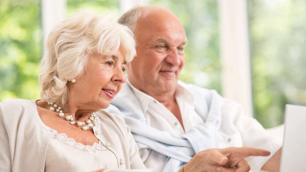 Older couple looking at a laptop screen