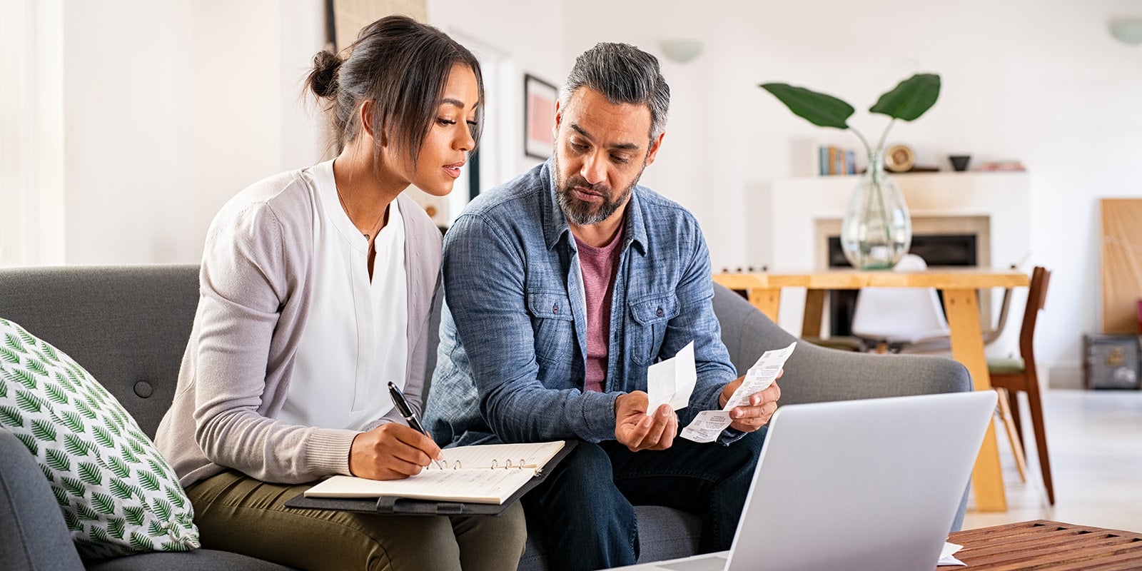two people at home sorting out their bills