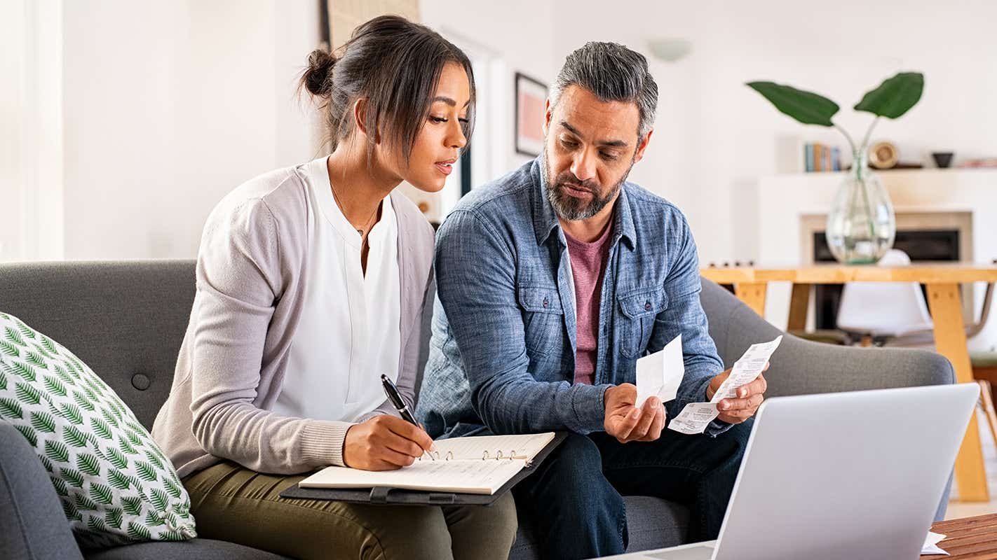 two people at home sorting out their bills