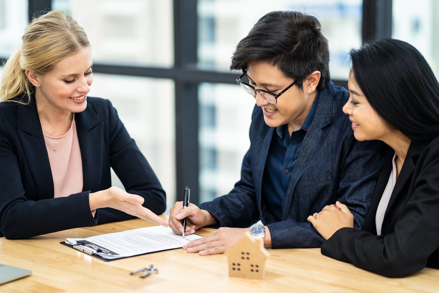 Asian couple signing mortgage documents