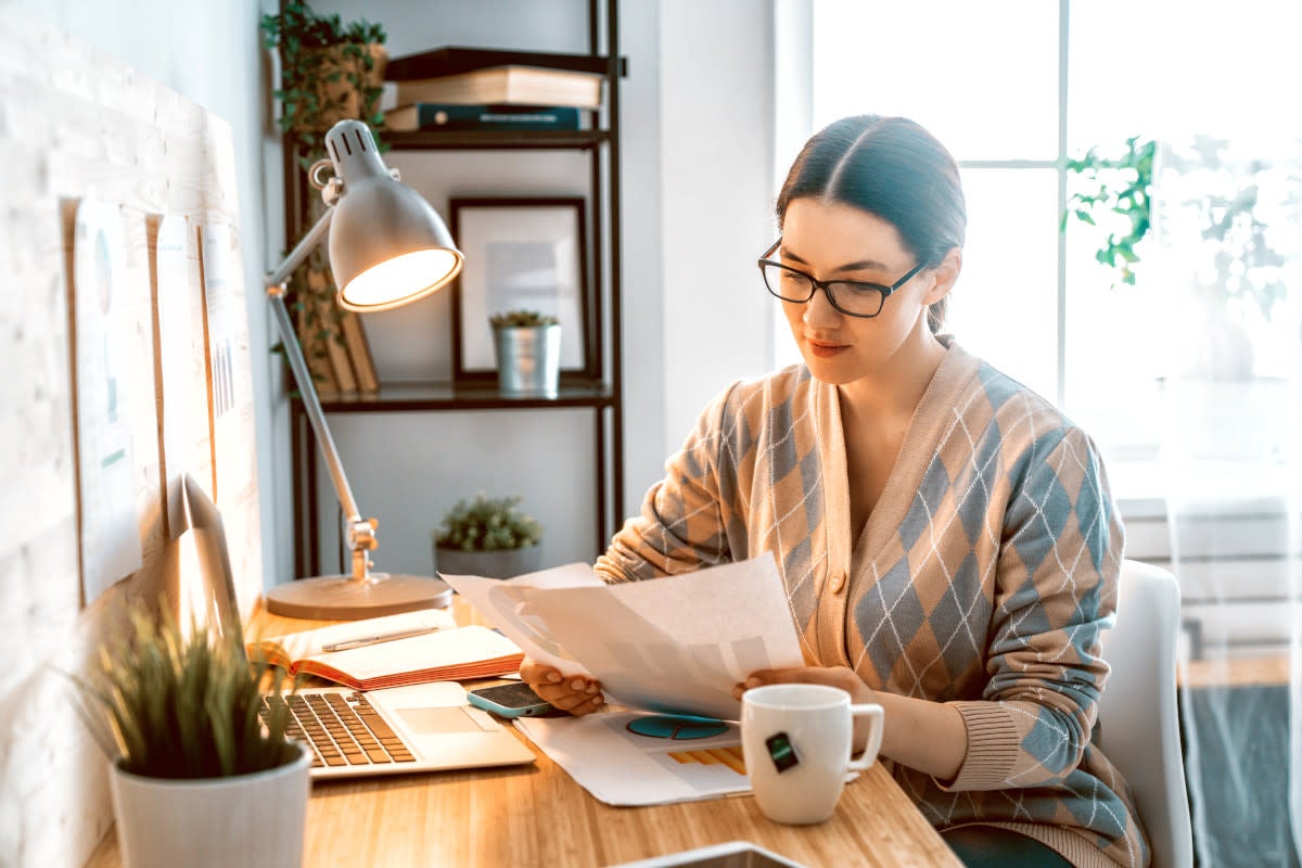 Woman looking at paperwork at home