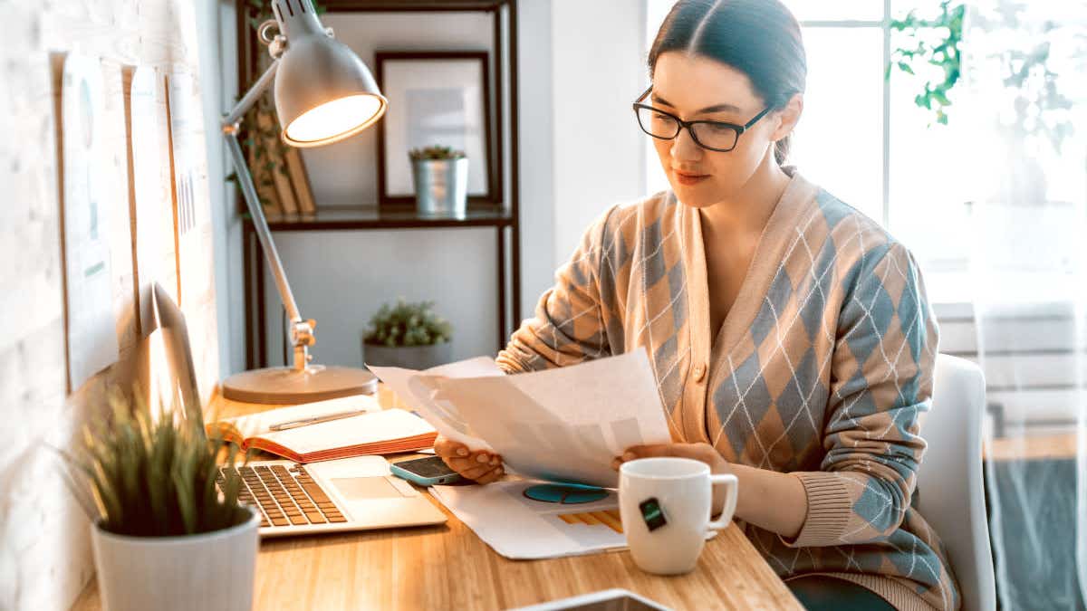 Woman looking at paperwork at home
