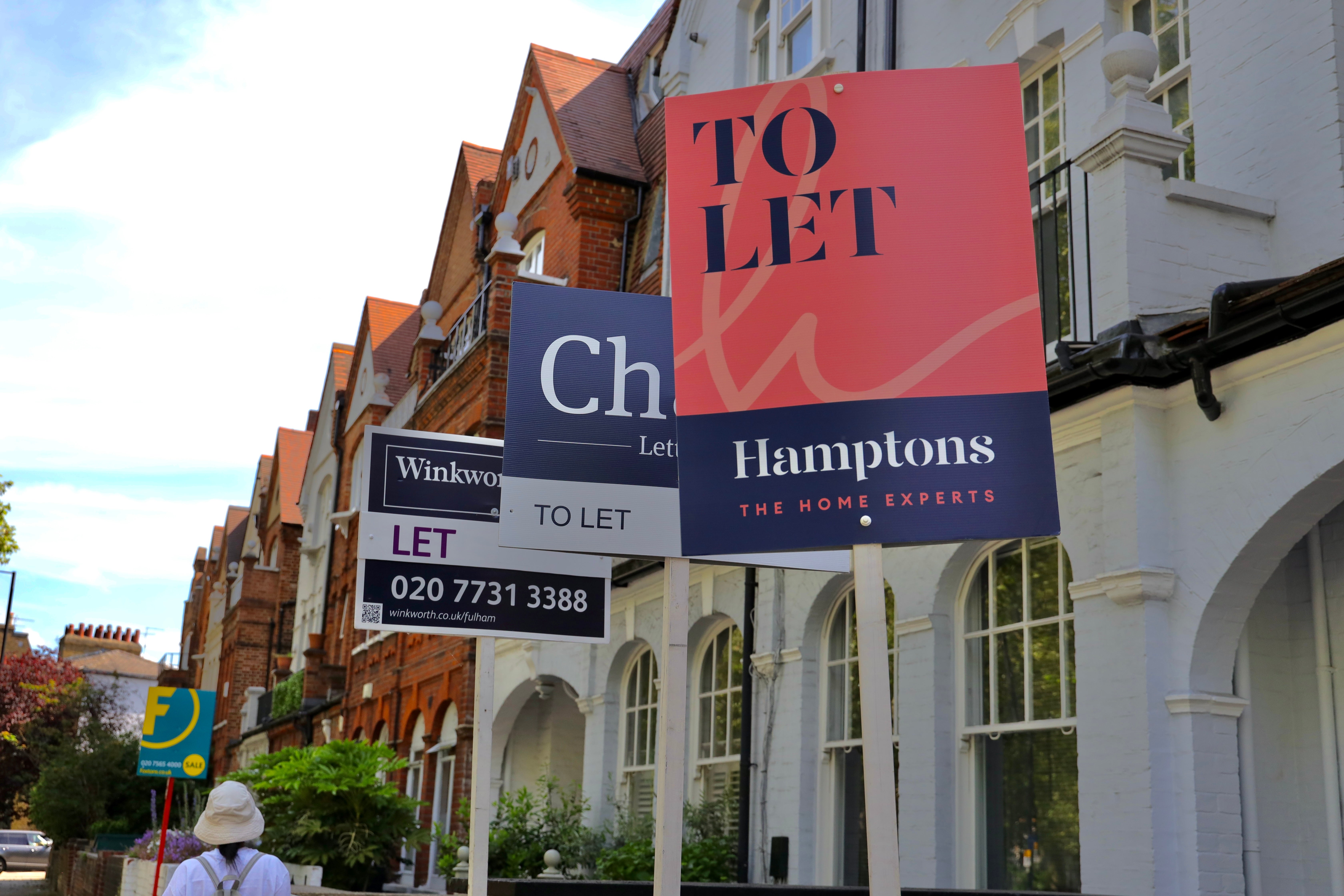 A row of UK terraced houses are shown, 3 of which have 'to let' signs posted in the front garden, to alert the fact that they are available for rental