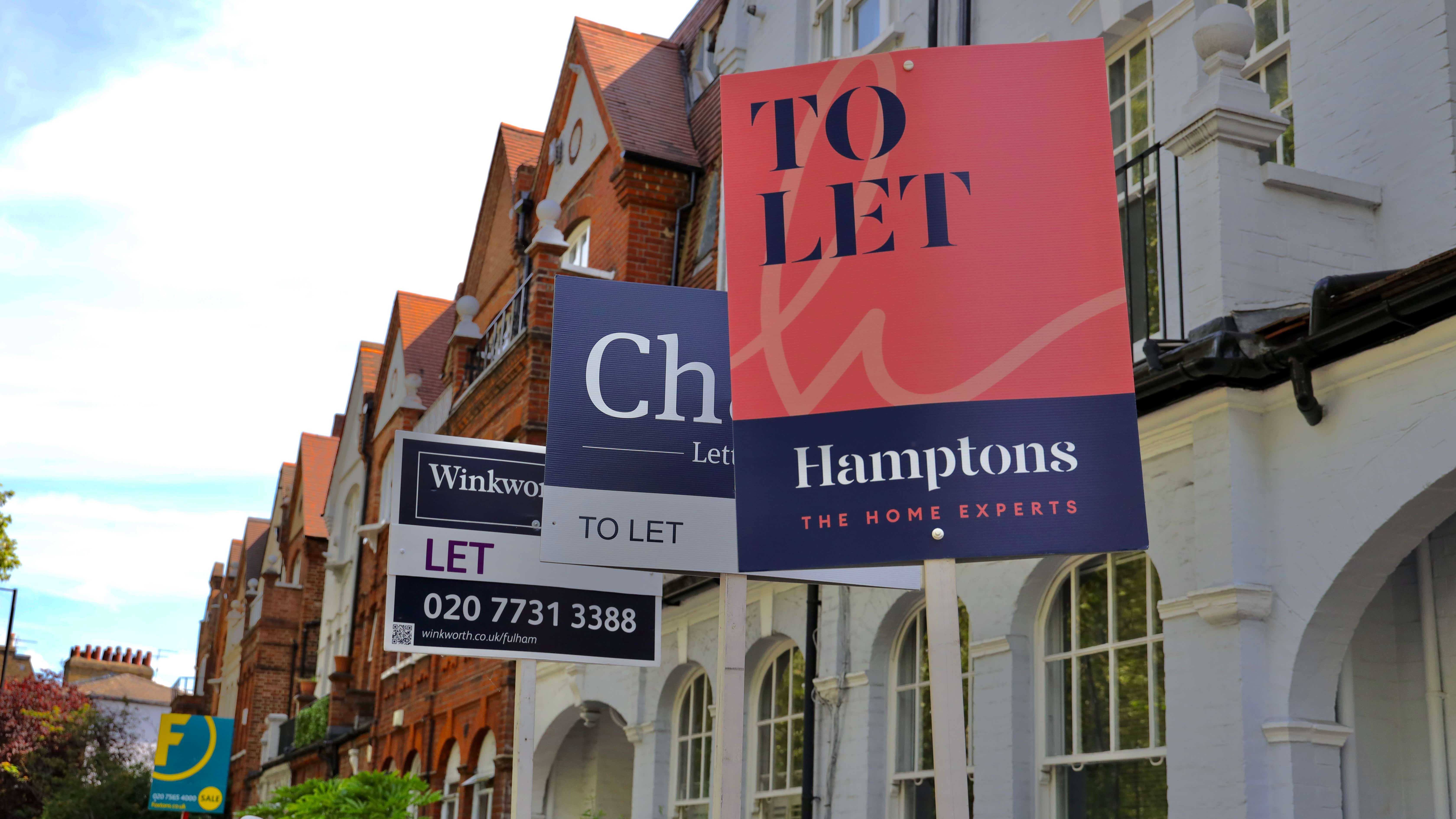 A row of UK terraced houses are shown, 3 of which have 'to let' signs posted in the front garden, to alert the fact that they are available for rental