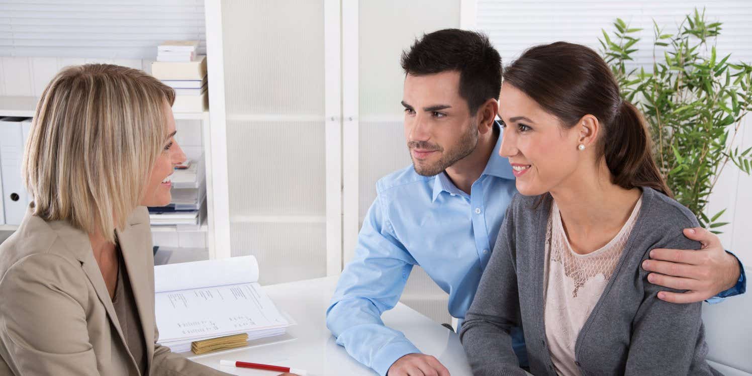 couple discussing mortgage with adviser