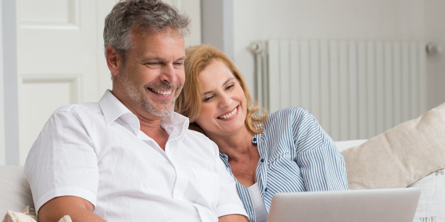 Mature couple looking at laptop