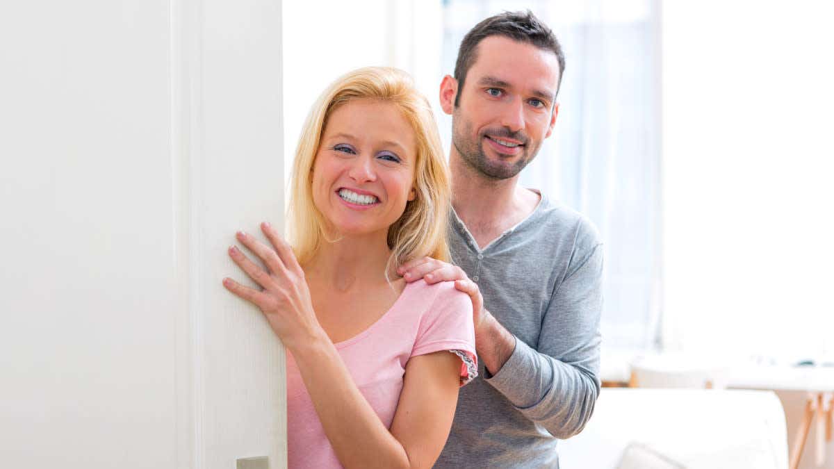 Man and a woman answer the door
