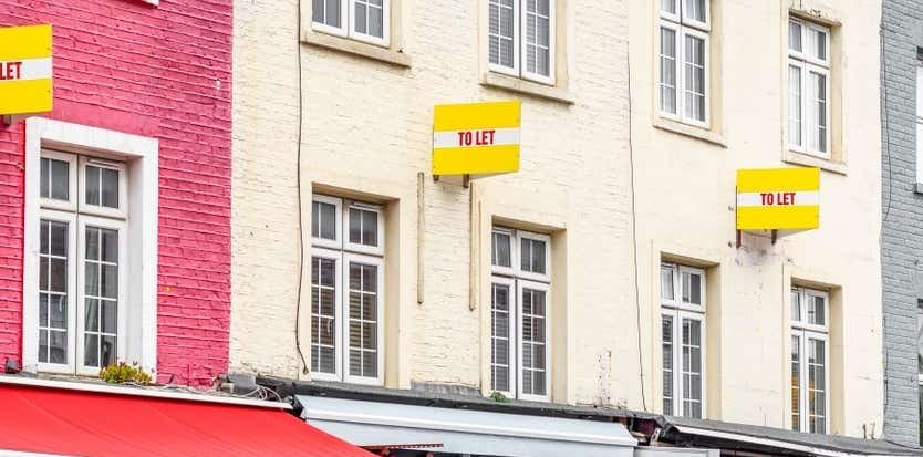 How to become a buy to let landlord. Image of colourful houses with To Let boards. 