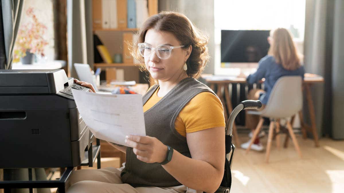 Woman in a wheelchair checking paperwork