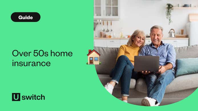 Older couple sat on sofa looking at laptop
