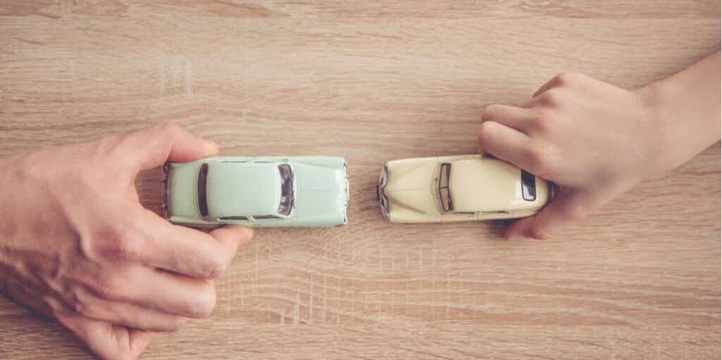 Adult and child playing with cars