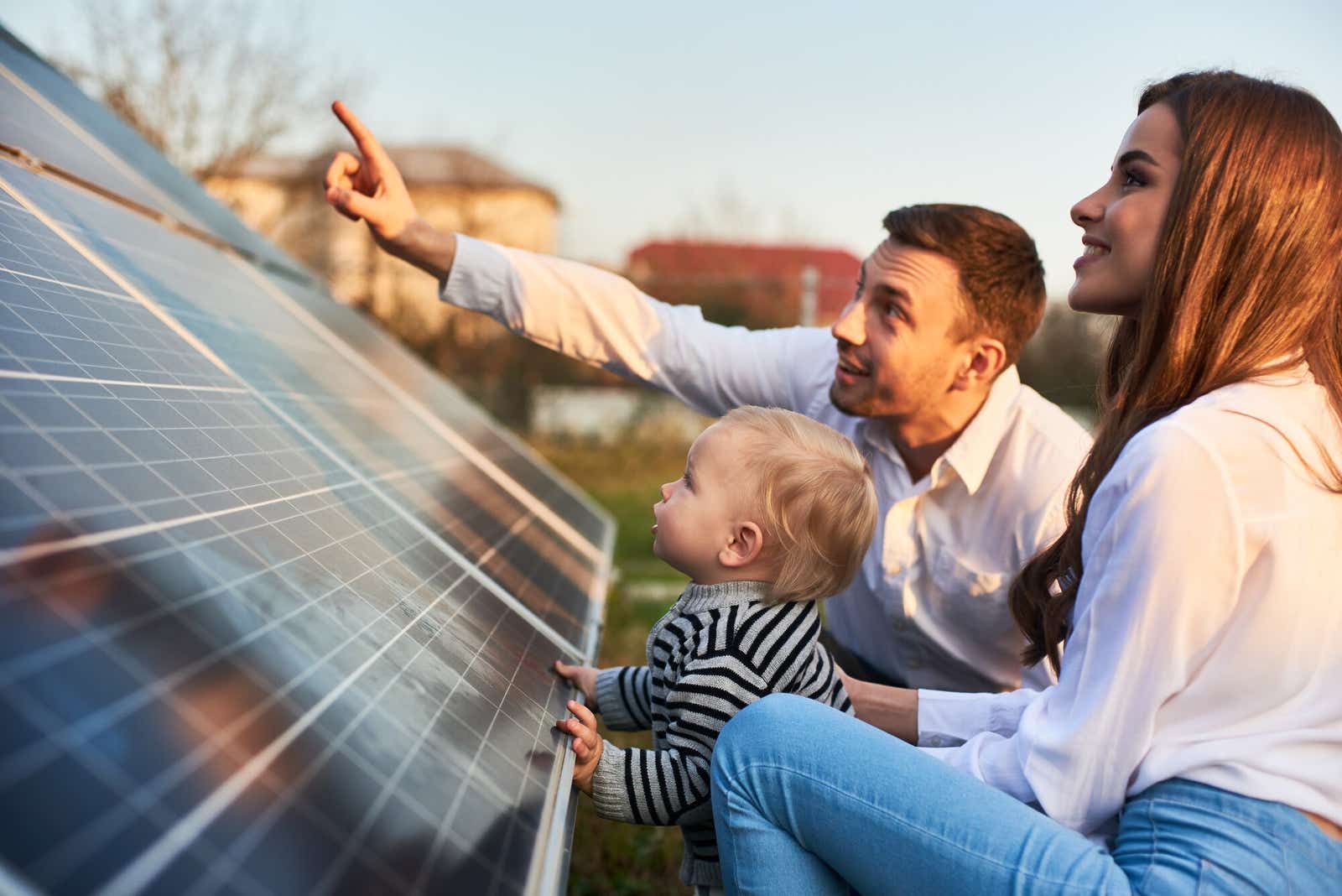 Family looking at their low carbon solar panels