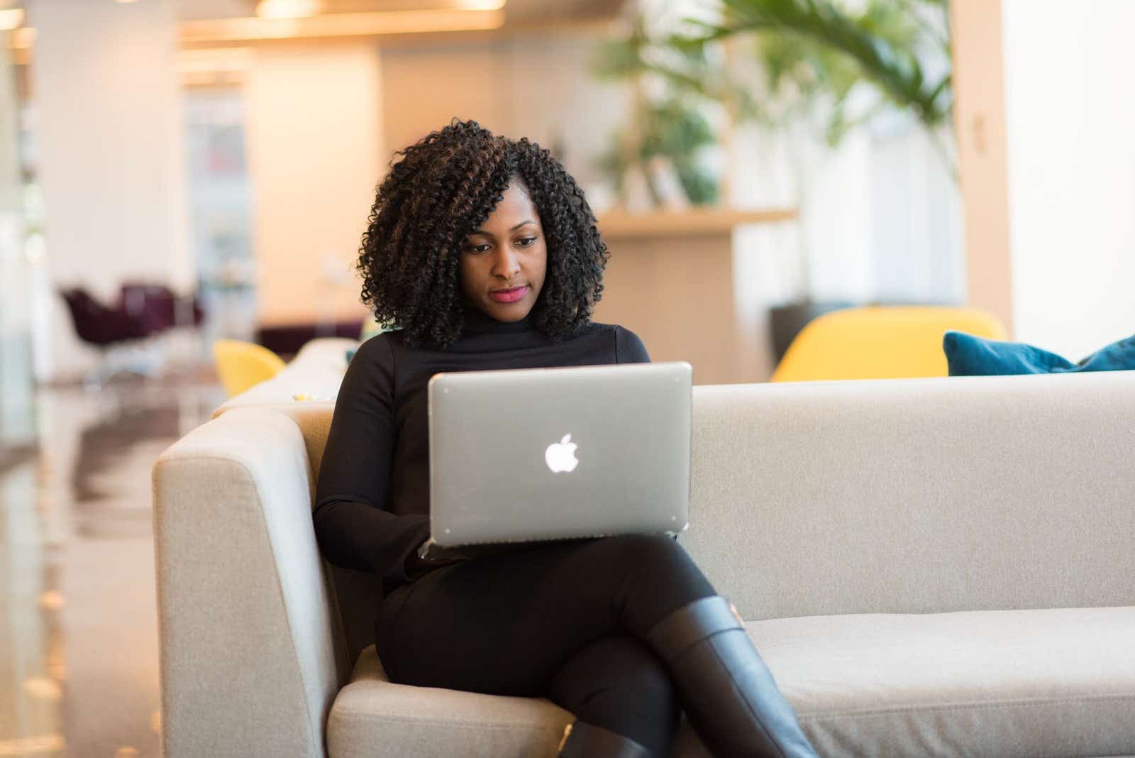 Woman on sofa using a laptop