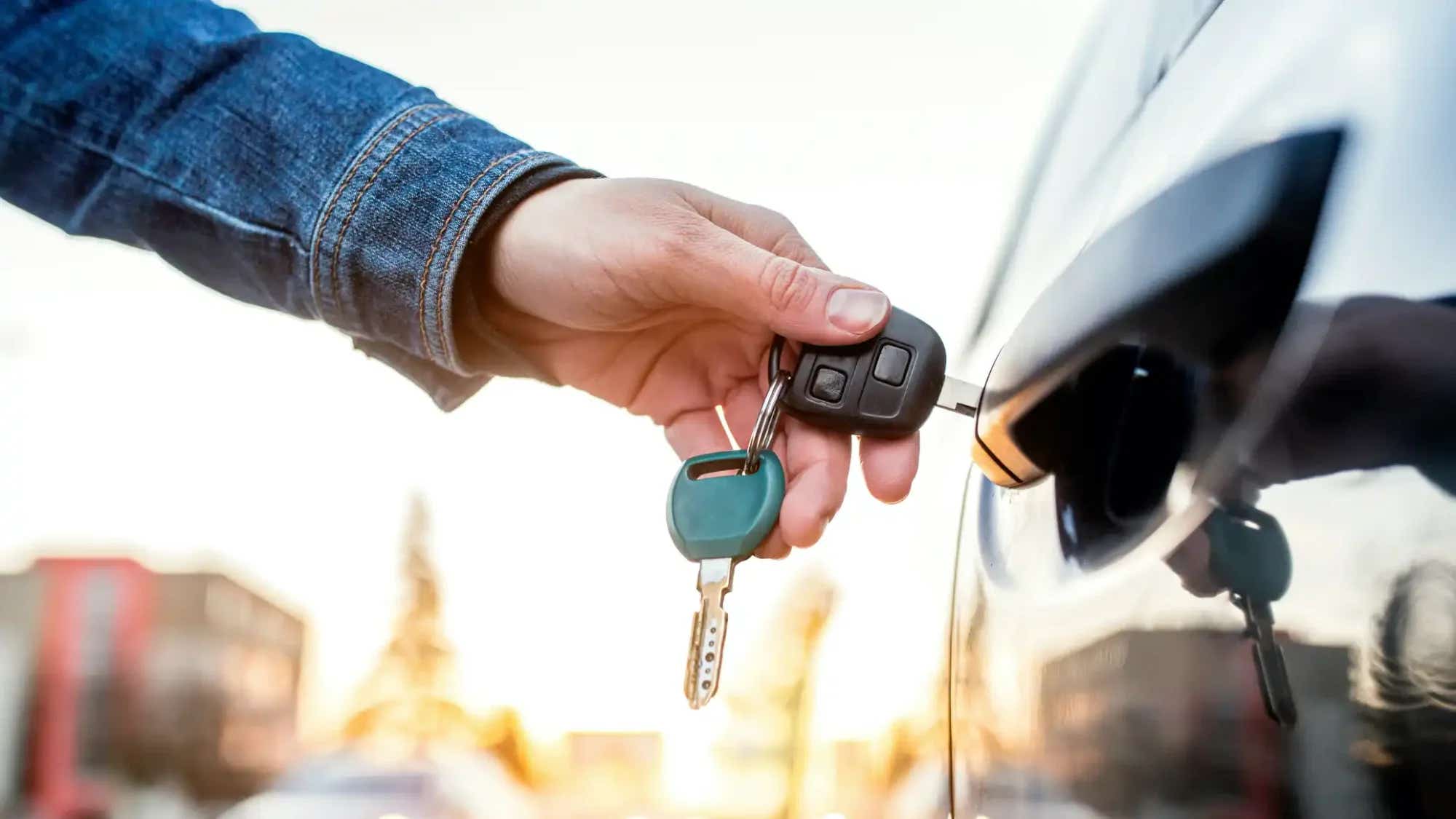 Person putting their keys into their car door