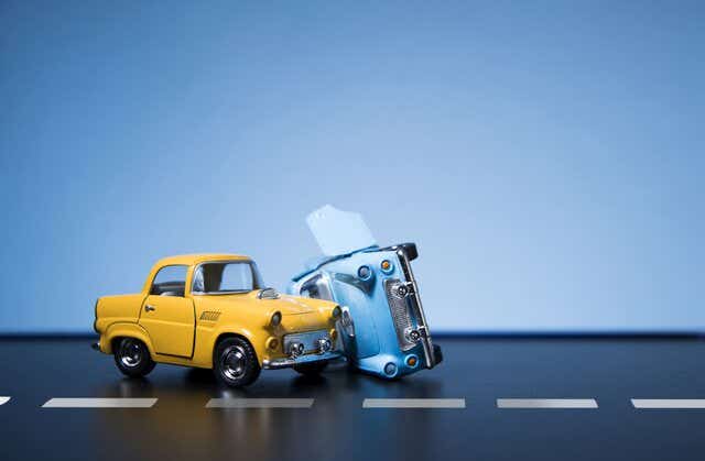 Classic fifties toy cars involved in a collision  