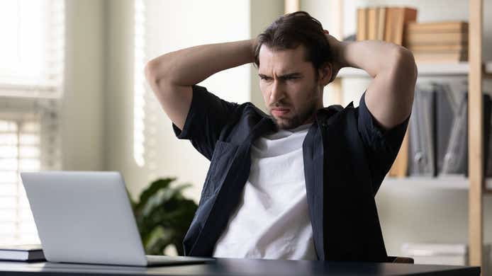 man looking disappointed at his laptop