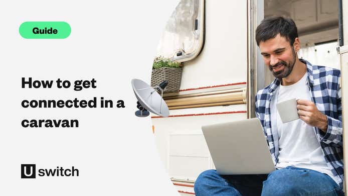 Man drinking a coffee while on a laptop while sitting in a caravan 