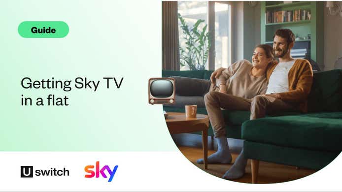 Couple watching sky tv at home in their flat