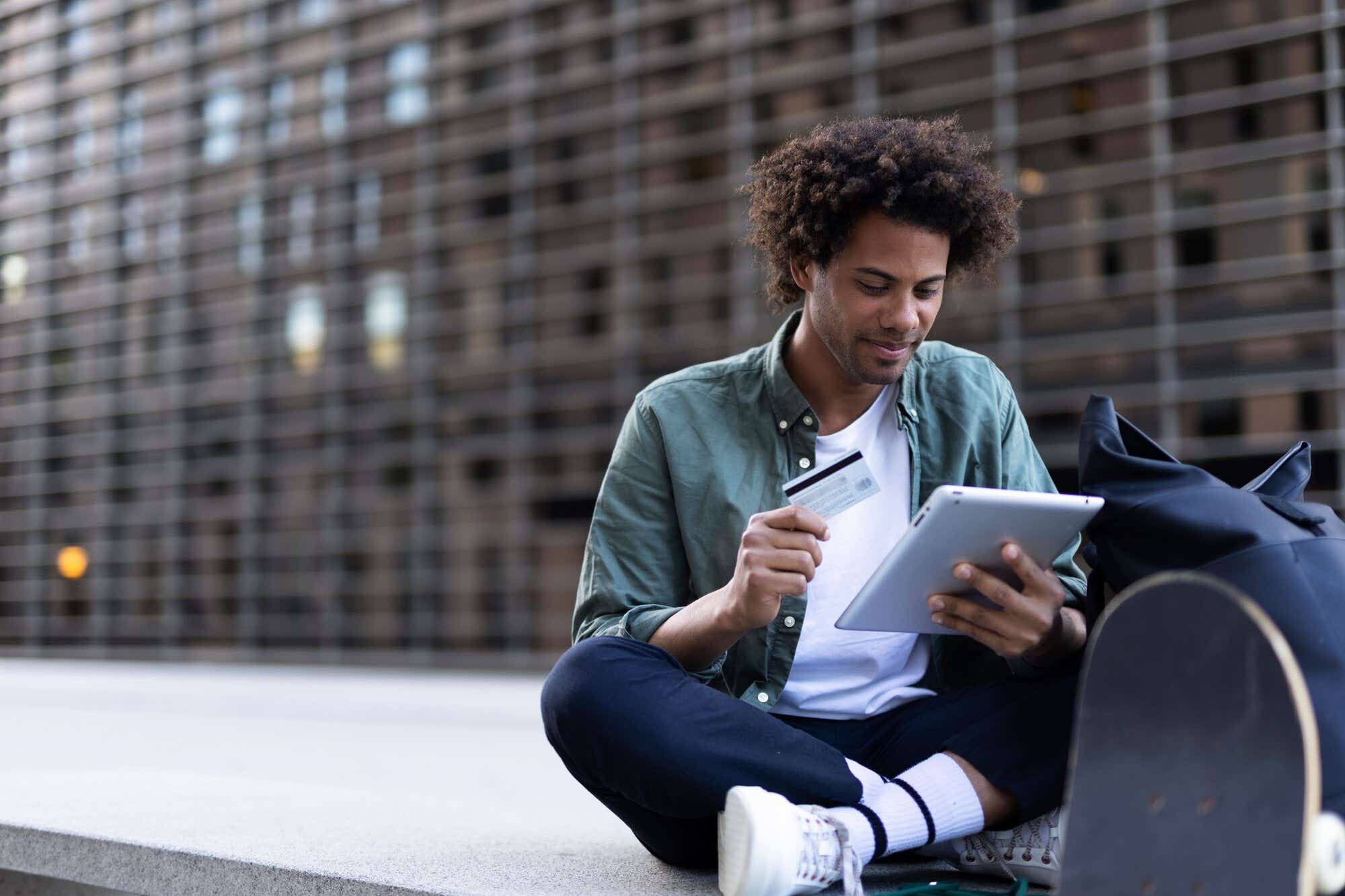 Student buying online with a credit card and a digital tablet