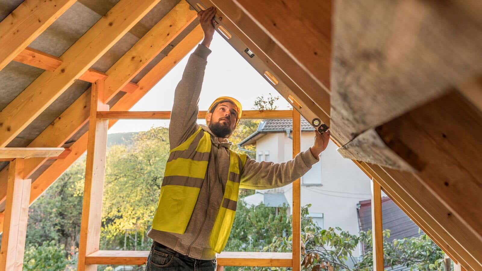 Builder working on the roof of a house 