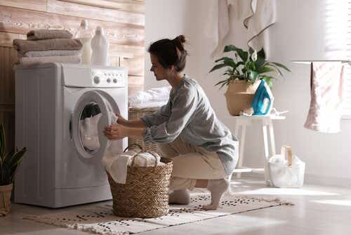 Woman loading washing machine