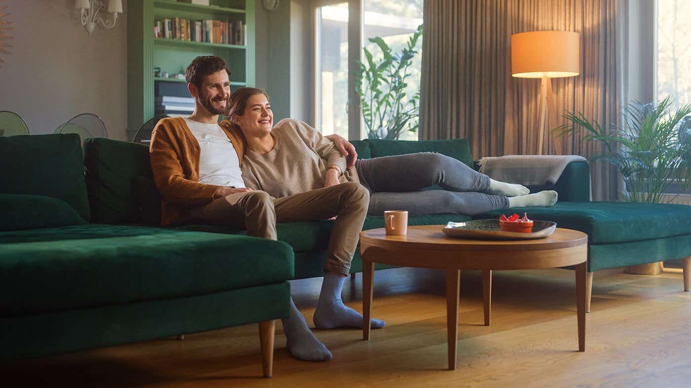 Couple sitting together on a sofa in their living room