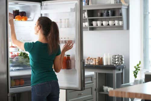 Woman reaching into fridge