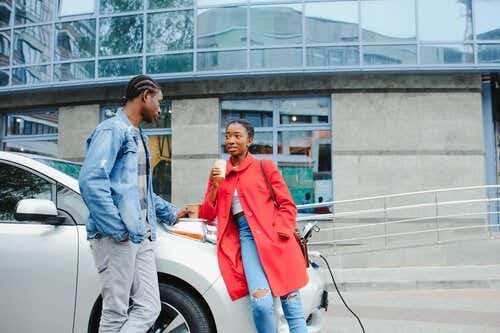 Couple waiting for electric car to charge