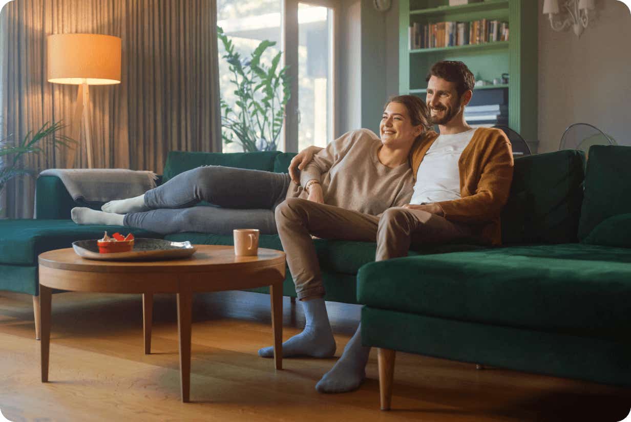 couple relaxed on the sofa watching tv