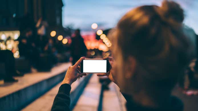 Woman taking photo with her smartphone camera