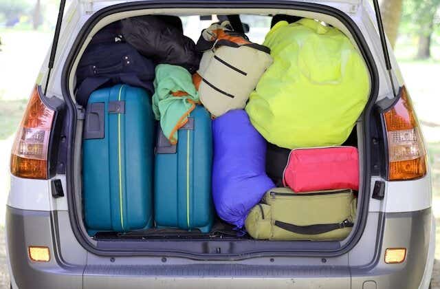 Suitcases and bags stuffed in a boot ready for a holiday.