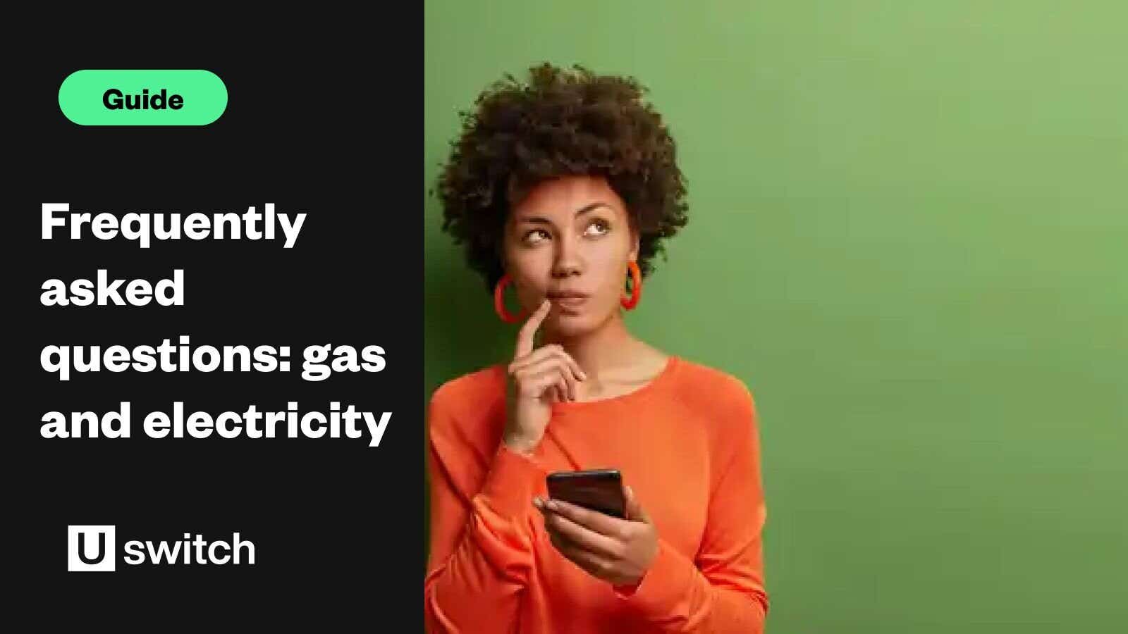 A brown-skinned woman with an Afro wears a bright orange shirt and matching earrings and stands in from of a plan green background. She has a phone in one hand and her other hand is pointing to her mouth with an inquisitive look on her face to denote confusion