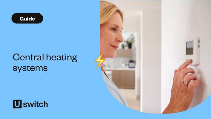 Woman adjusting central heating on wall