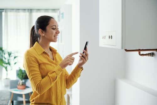 Woman using phone to control boiler