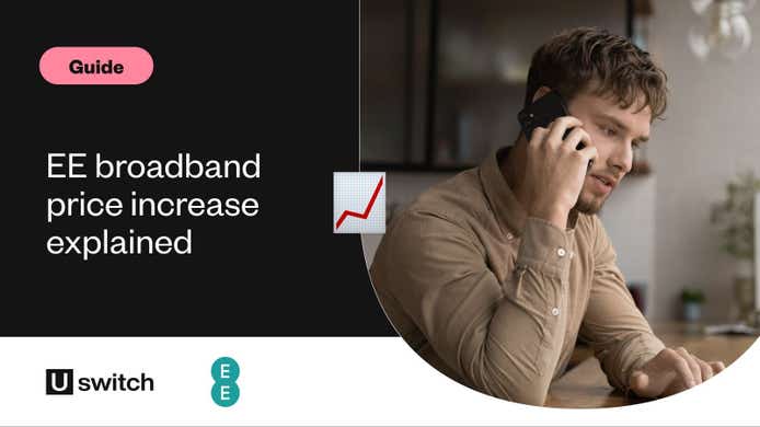 man sat at a desk on the phone while looking at his laptop