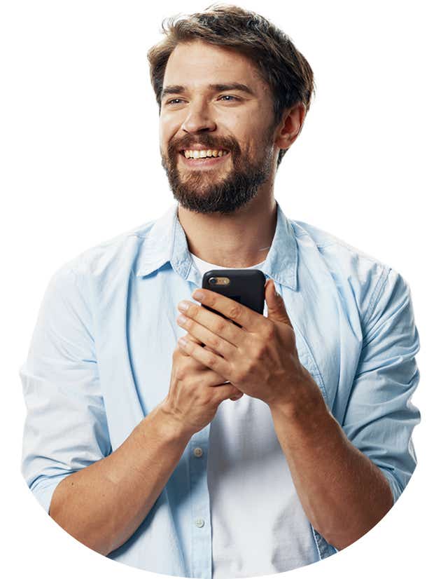 A man holding a phone and smiling 