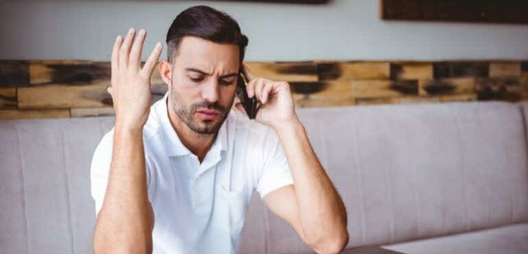 man disappointed while on the phone