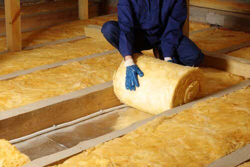 Worker installing floor insulation