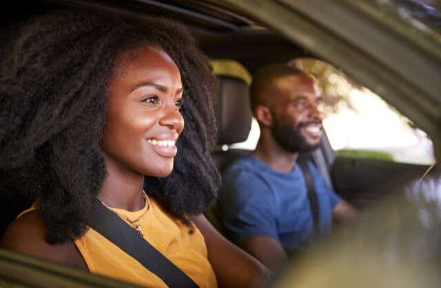 Young Woman Driving With Young Man