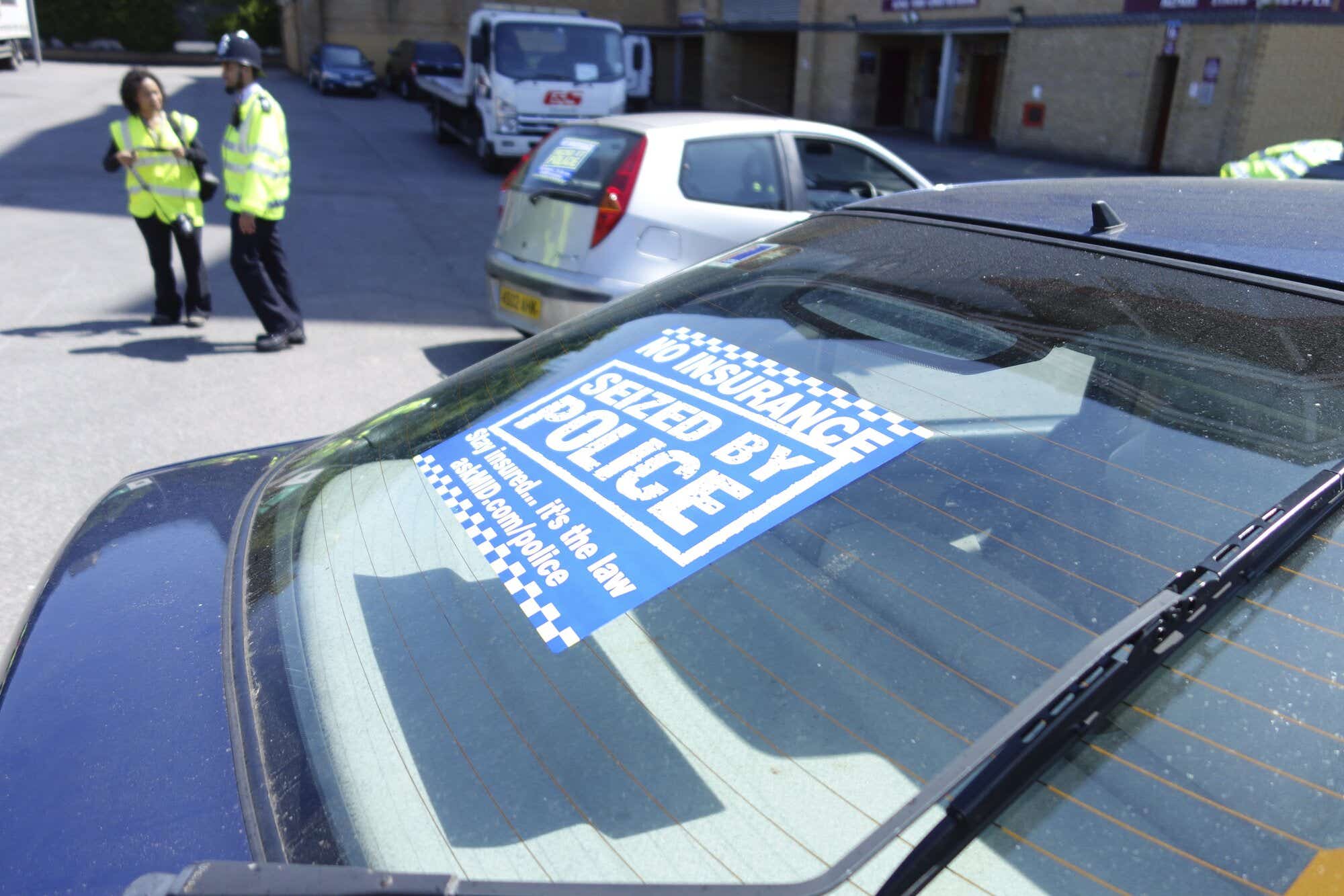 No insurance seized by police sticker on back of car window