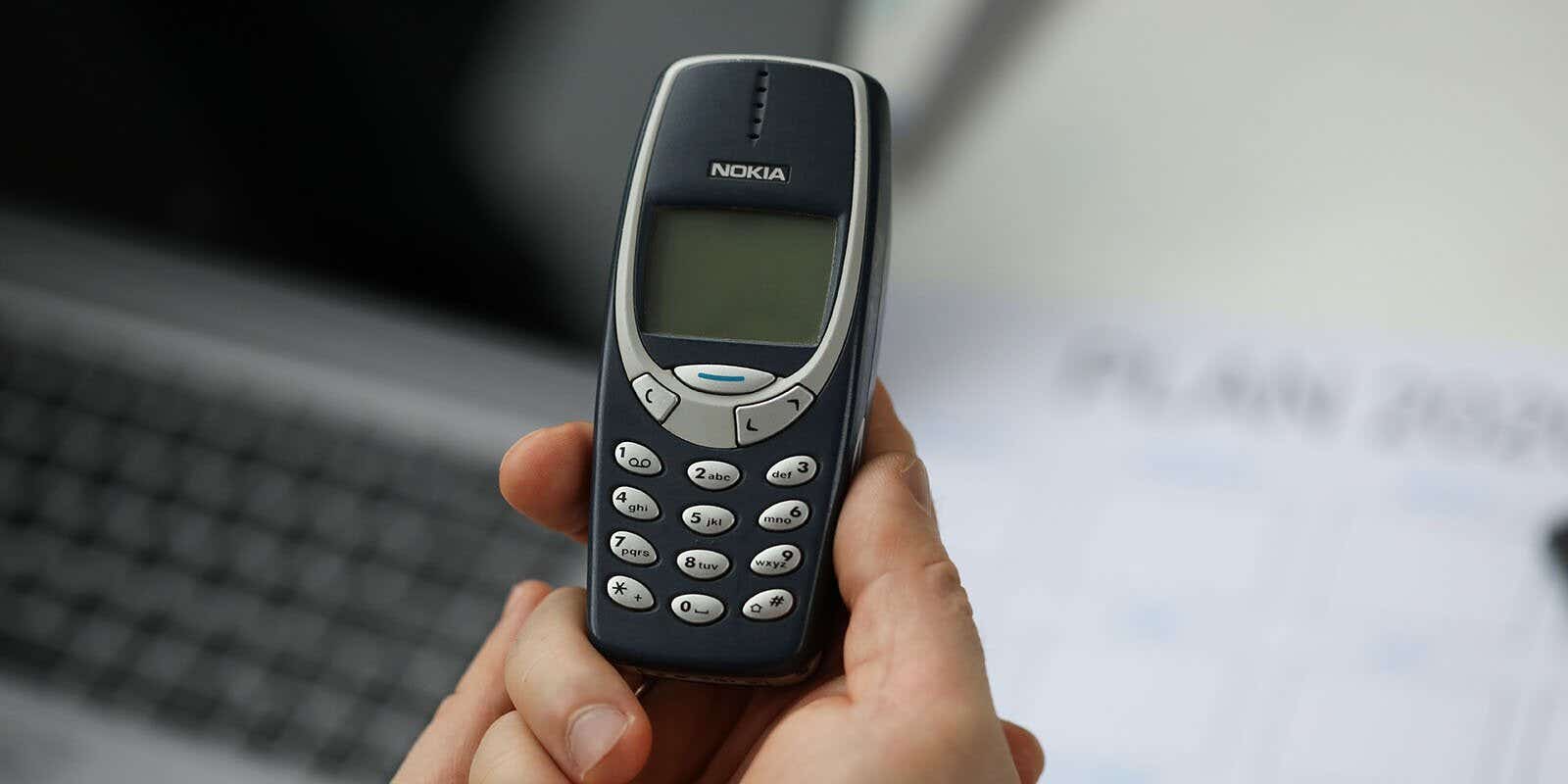 person holding an old nokia mobile phone