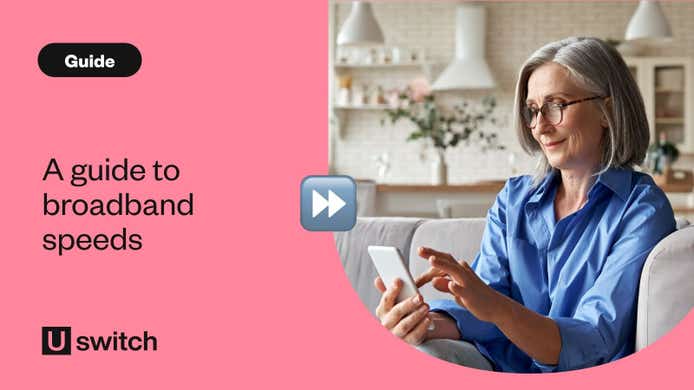 Woman using her phone while sat on her sofa at home