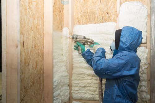 Worker installing wall insulation