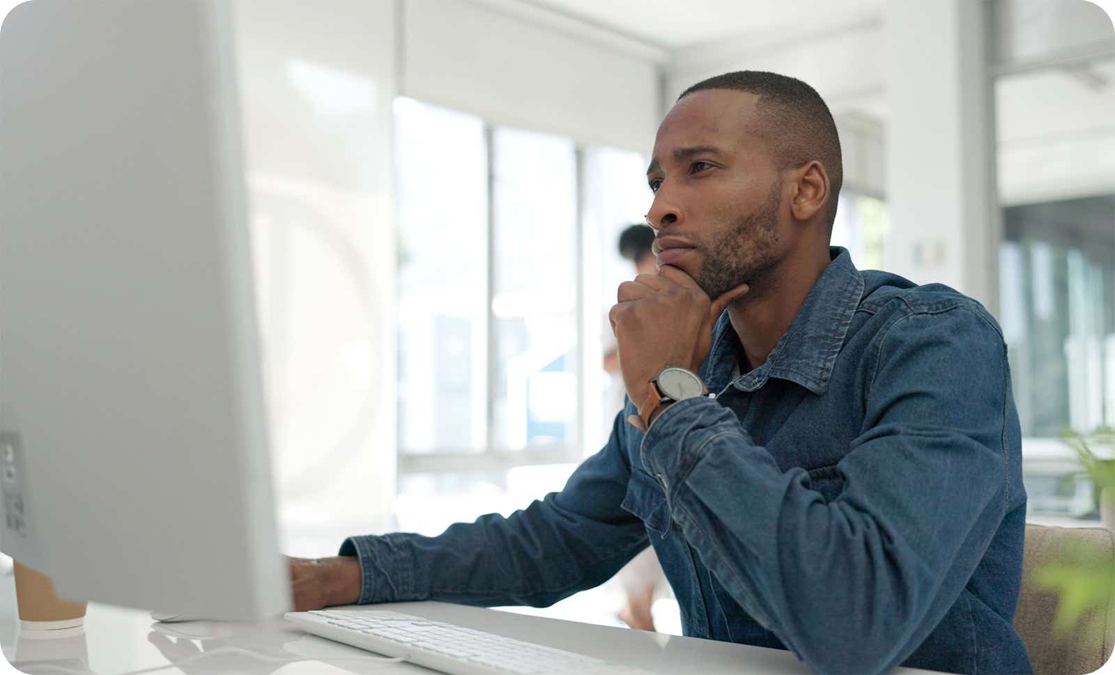 man working at his computer at home