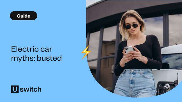 Woman checking phone leaning against an EV