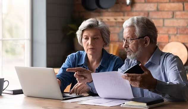 elderly couple paying their bills