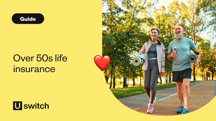 A couple walking in a park holding yoga mats and smiling