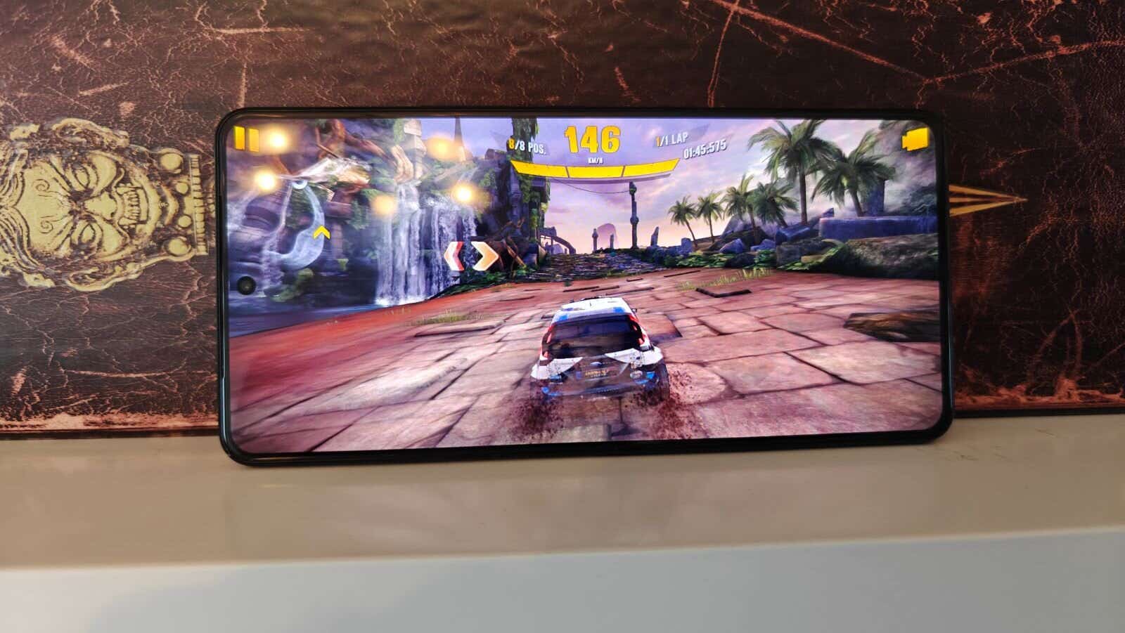 Car racing game being played on a mobile phone