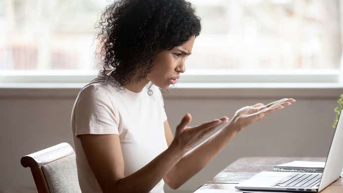 woman looking very frustrated with her broadband connection