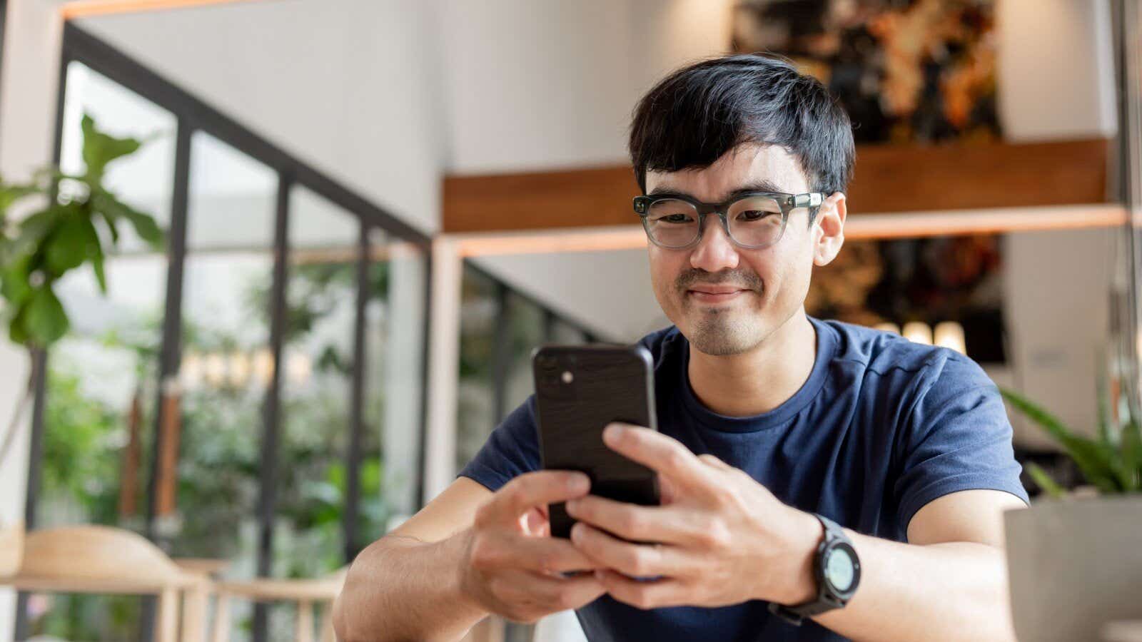 man using cell phone hand holding mobile texting